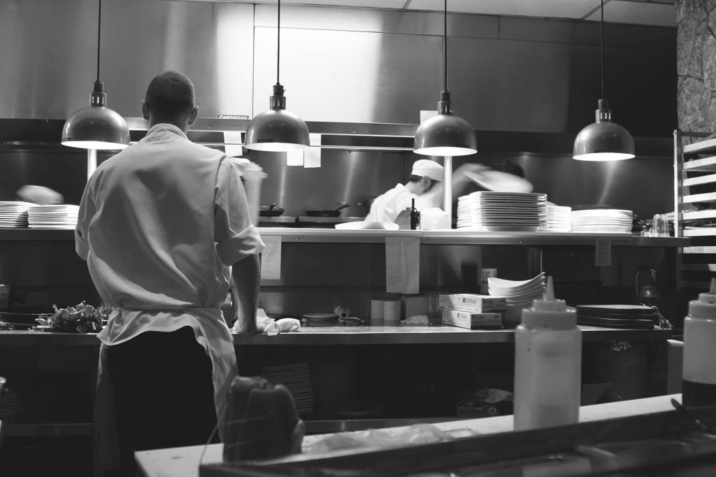 staff in the kitchen restaurant black and white